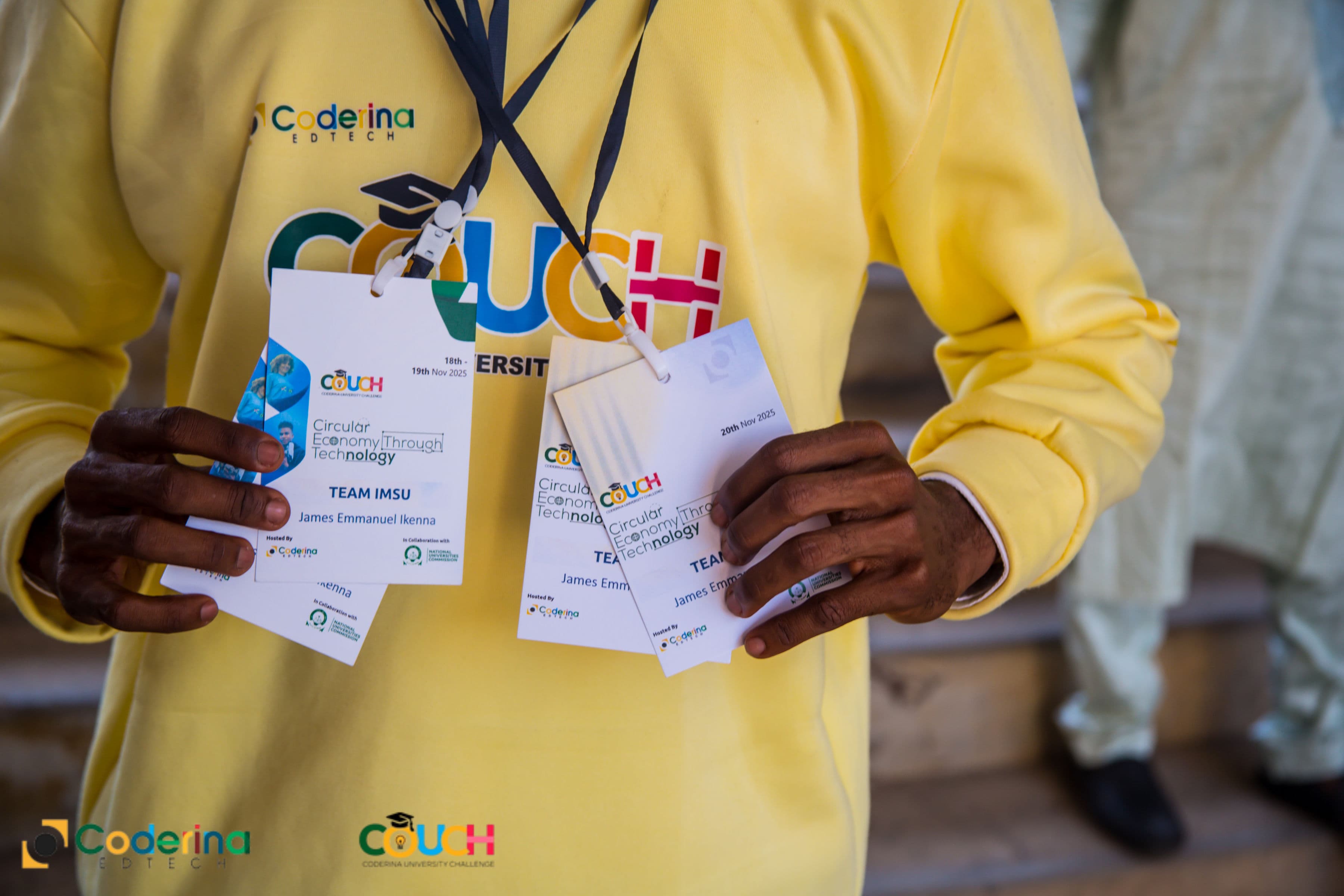 A COUCH participant from Team IMSU holding their event badges at the Coderina University Challenge